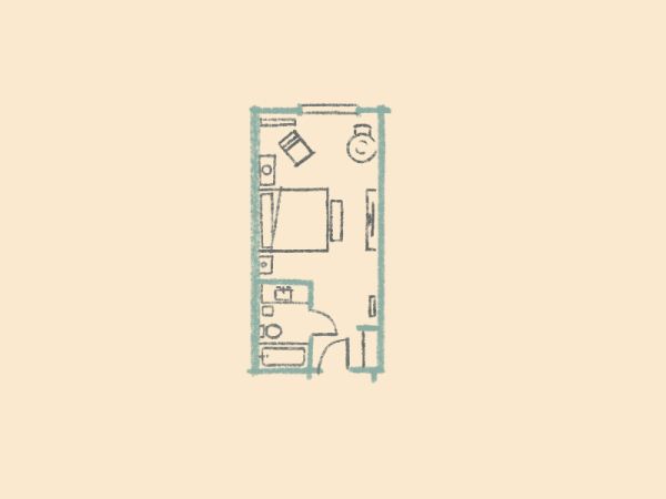 A small, rectangular floor plan showing a bedroom with a bed, desk, chair, small kitchen, bathroom, and storage space.
