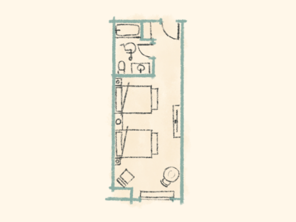 A compact apartment layout with a kitchen, bathroom, and two beds, plus a small seating area in a narrow, rectangular space.