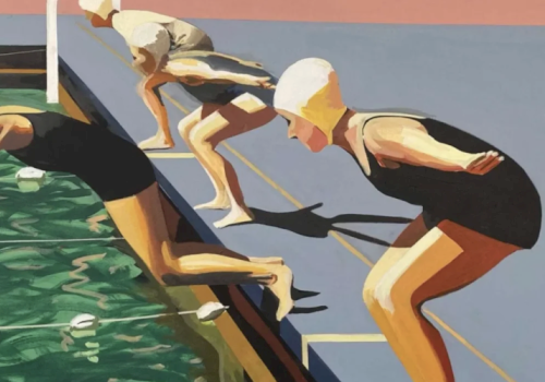 Three swimmers dive into a pool from a starting block.